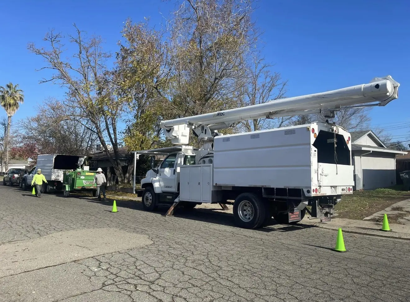 Tree-service truck and chipper in an established neighborhood