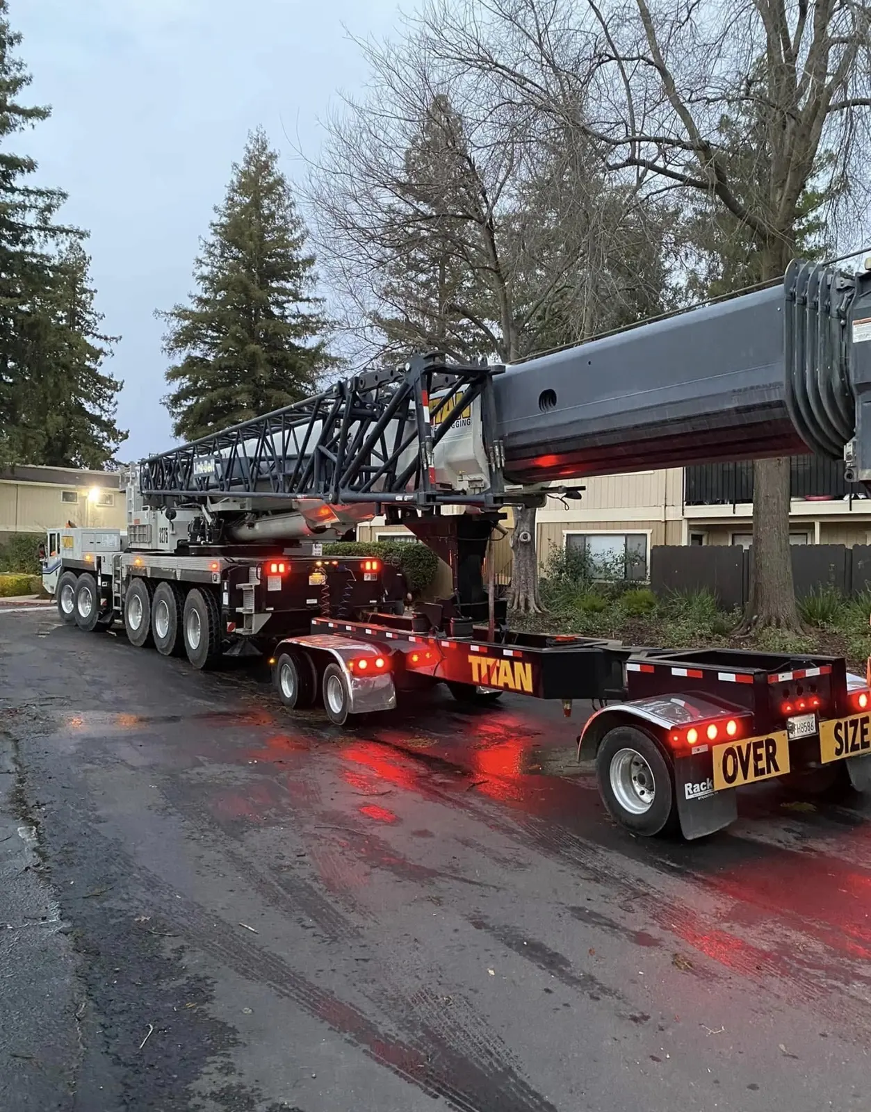 Large mobile crane arriving for a nighttime tree emergency